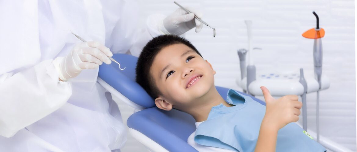 boy giving thumbs up at dentist